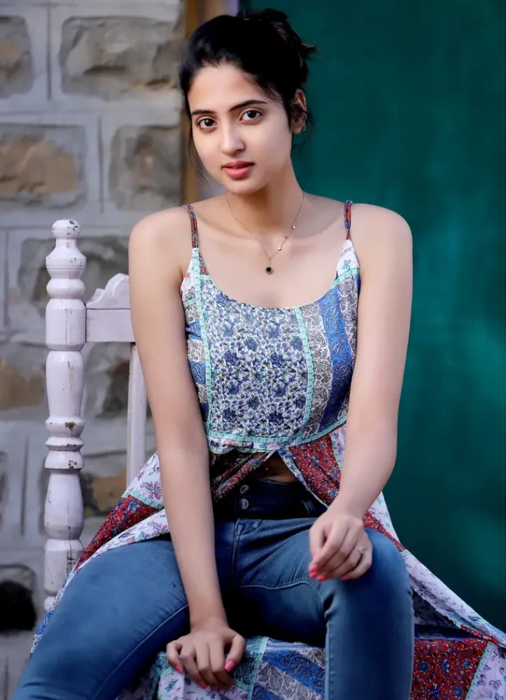 Vidula Chougule sitting on a Table