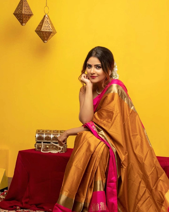 Priyanka Sharma sitting on a Table